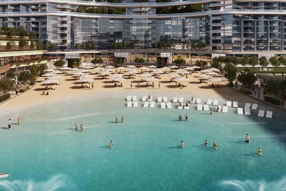 Residents enjoying artificial sandy beach and crystal lagoon at 350 Riverside Crescent in Sobha Hartland II, Dubai