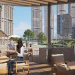 Residents enjoying outdoor dining and BBQ area with views of luxury towers at 350 Riverside Crescent in Sobha Hartland II, Dubai