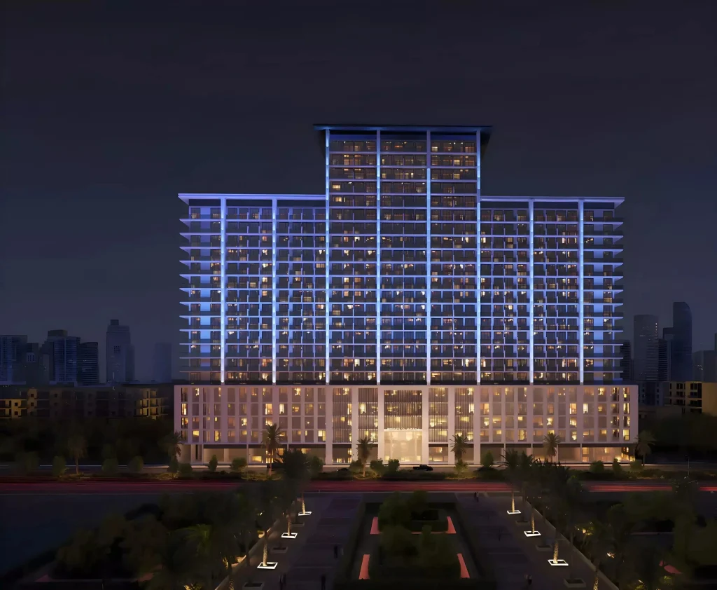 Illuminated night exterior facade of Binghatti Amberhall residential building in Jumeirah Village Circle Dubai
