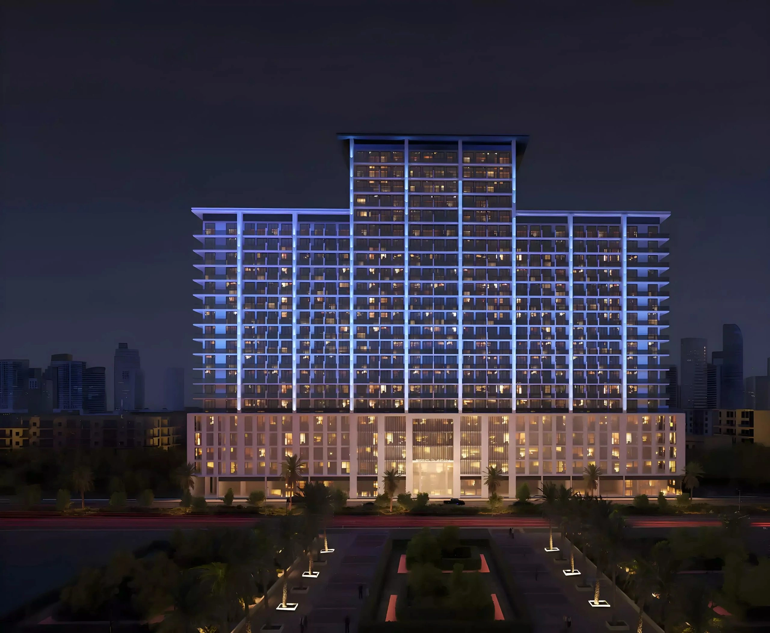 Illuminated night exterior facade of Binghatti Amberhall residential building in Jumeirah Village Circle Dubai