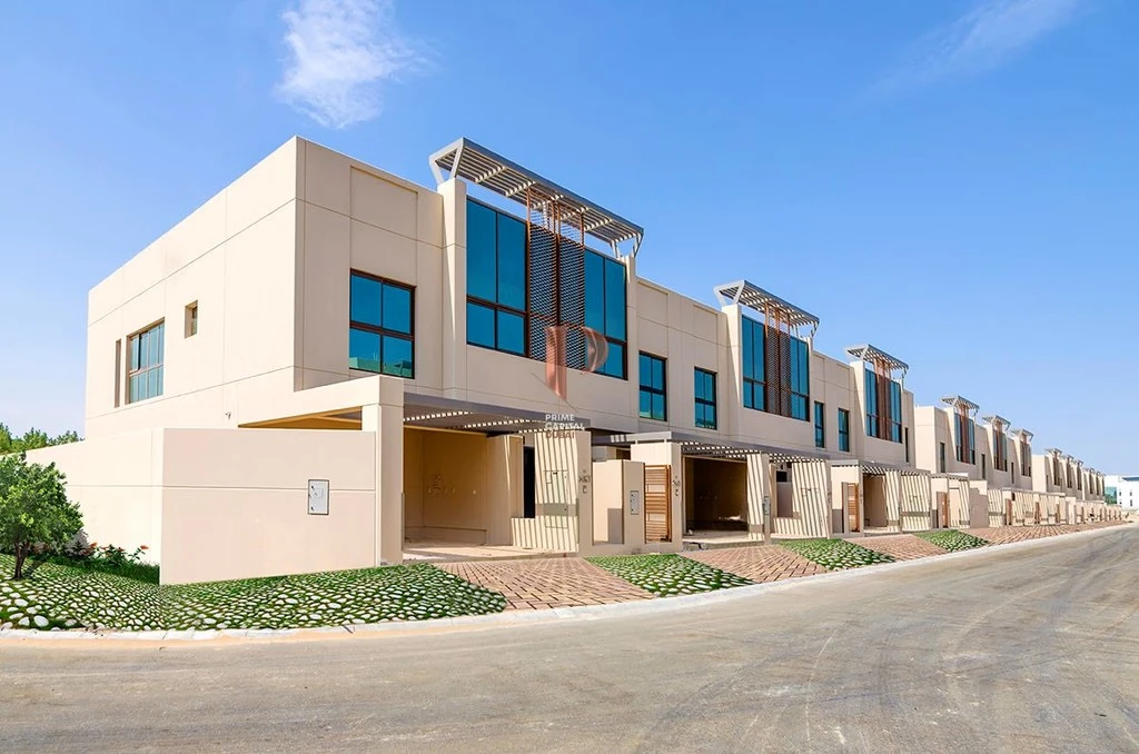 Street view of modern townhouses row with glass facades and covered driveways at Grand Views in Meydan Dubai