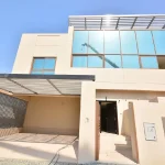Modern 4 bedroom townhouse exterior facade with covered parking garage and large glass windows at Grand Views in Meydan Dubai