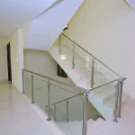 Marble internal staircase featuring stainless steel and glass railings inside Grand Views townhouse at Meydan Dubai