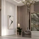 Modern reception desk with green marble Binghatti branding wall and elevators at Binghatti Amberhall in Jumeirah Village Circle, Dubai