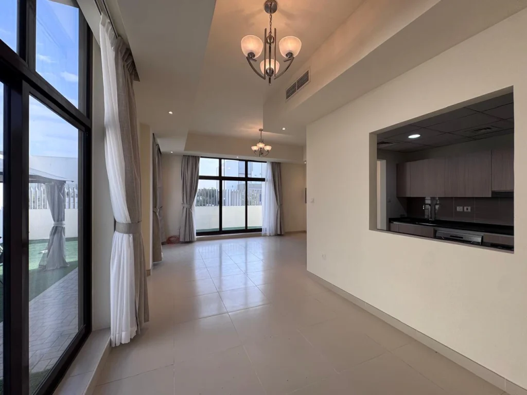 Spacious balcony with glass railing overlooking the neighborhood street at Senses at The Fields townhouse in Dubai