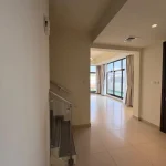 Modern interior entrance hallway featuring glass staircase and living space in a 4 bedroom townhouse at Senses at The Fields Meydan